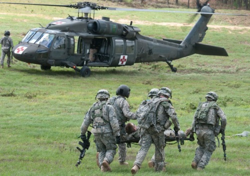 army medic conducting an evacuation of a patient