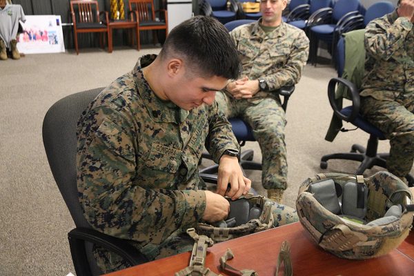 0300 MOS Staff Sergeant evaluates a helmet retention system