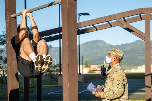 Soldier performs leg tuck forThe Army Combat Fitness Test (ACFT)
