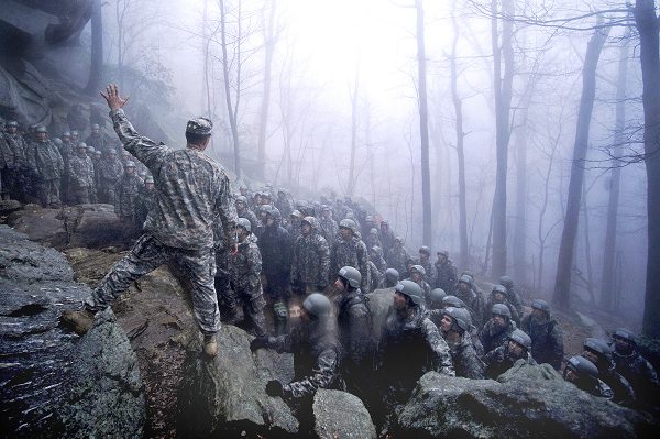 U.S. Army Ranger instructor explains the technical instructions of rappelling during Mountain training