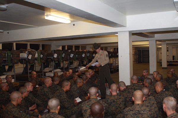 Drill instructor passes out boot camp letters to Marines