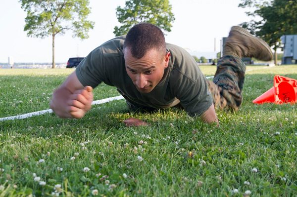 Marine executes a high crawl during the maneuver under fire portion of the Marine CFT