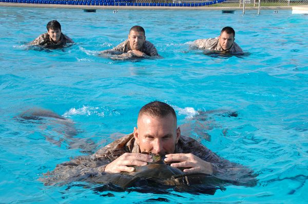 Marines use their packs as floatation devices during USMC swim qual