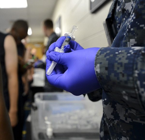 Recruits at Recruit Training Command (RTC) standby to receive immunizations