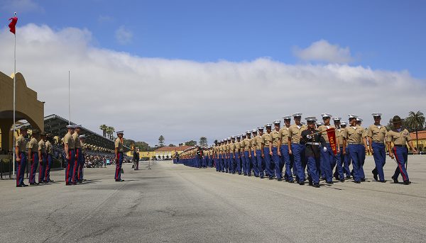 Marines march across the parade deck during a graduation ceremony at Marine Corps Recruit Depot