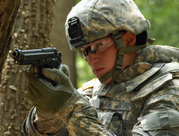 A United States Army soldier in 2009 demonstrates the usage of his Beretta M9 sidearm.
