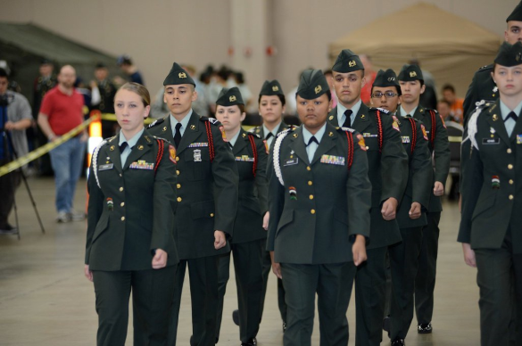 jrotc cadets marching in a high school auditorium