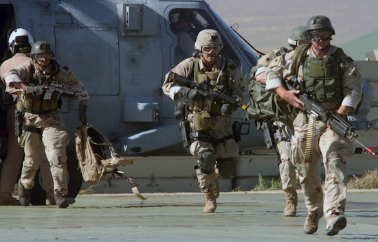 navy seals disembark from a helicopter