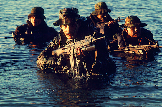navy seals emerge from the water in a training exercise